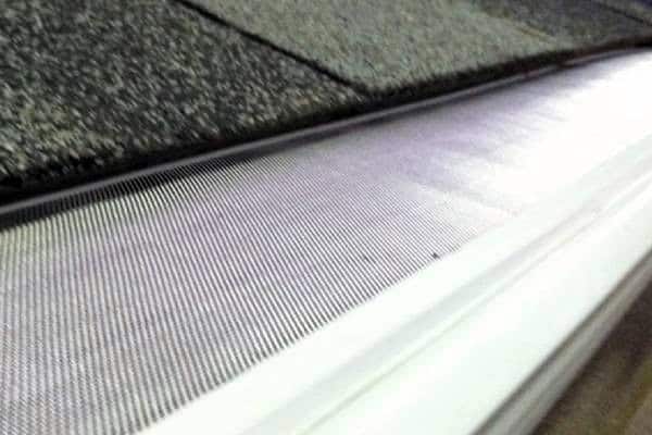 Gutter screen system for effective water drainage and debris prevention.