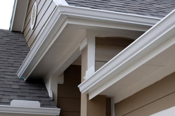 Close-up of clean, well-installed gutters on a residential house.